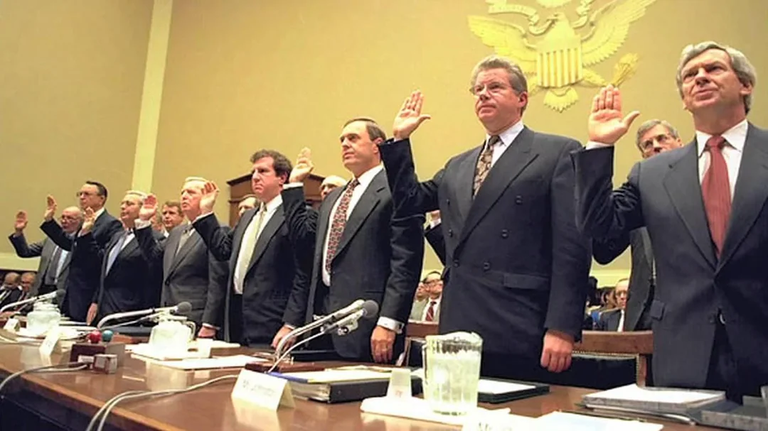 Seven tobacco company chief executives, plus one aide, standing with right hands raised as they are sworn in before a House subcommittee on April 14, 1994.